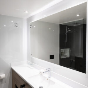 Thumbnail of http://A%20clean%20bathroom%20featuring%20a%20sink%20and%20a%20mirror%20above%20it,%20reflecting%20the%20room's%20bright%20lighting.