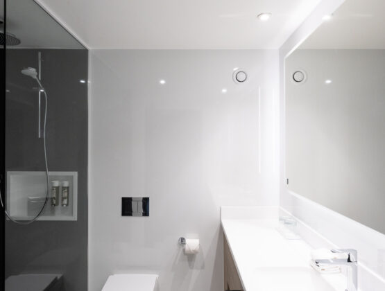 A sleek modern bathroom featuring a glass shower and contemporary fixtures.