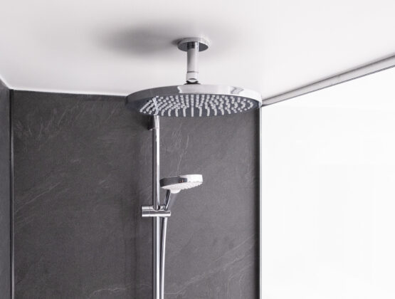 A close-up of a shower head featuring multiple spray settings and a sleek design, mounted on a tiled wall.