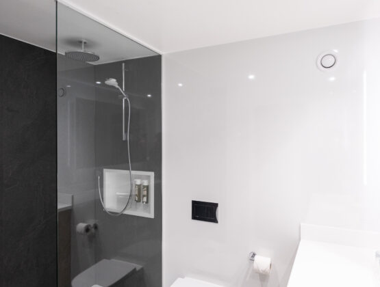 A sleek modern bathroom featuring a glass shower stall and contemporary fixtures.