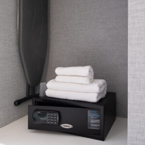 Thumbnail of http://A%20closet%20space%20featuring%20an%20ironing%20board,%20a%20hotel%20room%20safe%20and%20spare%20towels.