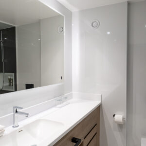 Thumbnail of http://Interior%20view%20of%20a%20bathroom%20with%20a%20sink,%20mirror,%20and%20toilet,%20emphasising%20a%20simple%20and%20practical%20layout.