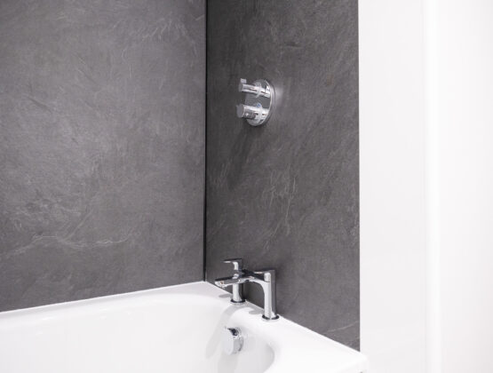 A bathroom featuring a bathtub and a shower, showcasing a clean and modern design.
