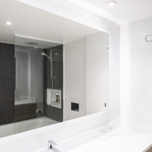 Thumbnail of http://A%20contemporary%20bathroom,%20showcasing%20a%20clear%20glass%20shower%20and%20a%20modern%20sink%20setup%20featuring%20a%20large%20mirror.