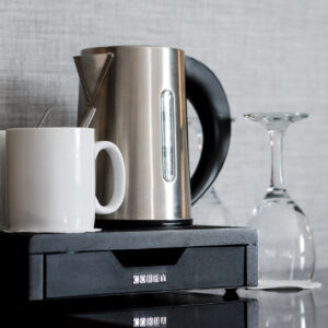 Thumbnail of http://A%20kettle,%20two%20mugs%20and%20two%20glasses%20are%20placed%20on%20a%20desk,%20ready%20for%20brewing%20and%20serving%20coffee.