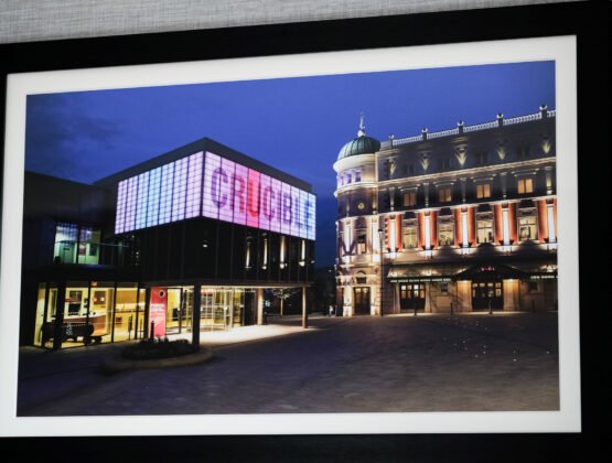 A framed photo of The Crucible, an iconic landmark in Sheffield, showcasing its architectural details at night.