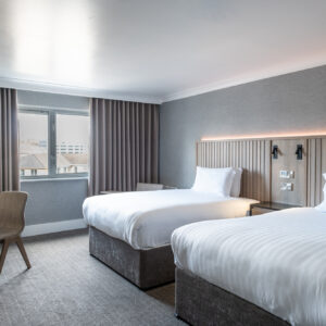 Thumbnail of http://Sophisticated%20hotel%20room%20with%20two%20plush%20beds,%20showcasing%20a%20breathtaking%20view%20of%20the%20cityscape.