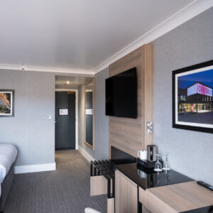Thumbnail of http://Interior%20of%20a%20hotel%20room%20with%20two%20beds%20and%20a%20television,%20showcasing%20a%20cozy%20and%20inviting%20atmosphere.